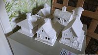 All six white ceramic village buildings on surface