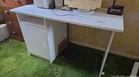 Front oblique view of desk showing left cabinet and top surface