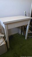 Front view of white table showing overall structure and wear