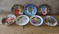 All seven Christmas collector plates displayed