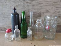 All eight glass items arranged upright on surface