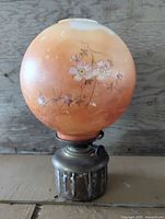 Full view oil lamp with globe and metal base