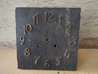 Front view of wood clock case showing numeral dial and missing hands