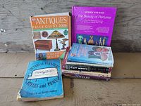 All seven books standing and stacked, front covers visible