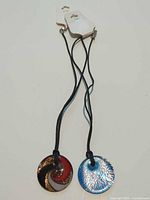 Both pendant necklaces with retail hang tags visible
