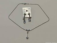 Full view of necklace and both earrings