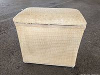 Front view of beige wicker ottoman