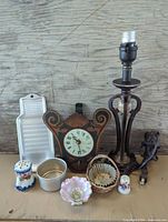 Overview of all items including lamp, clock plaque, ceramics, metalware, basket