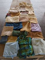 Full layout of assorted fabric pieces and sheer panels on table