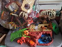 Overview showing bag of parts plus cave base, skeleton ribs and figures