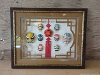 Full view of framed mask shadow box