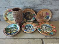 Full group view of six plates and carved chalice