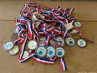 Pile of medals with striped ribbons