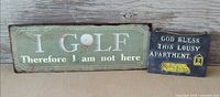 Both metal plaques side by side for scale and overview