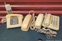 All five phones grouped: Lonestar feature phone, square keypad phone, two slimline phones, cordless handset