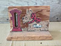 Front view showing Scottie dog, red hydrant, glass thermometer tube, Perth badge