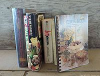 All six cookbooks standing showing spines