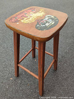 Full view of stool showing painted seat and legs