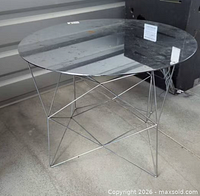 Full view of table showing mirrored top and chrome wire base