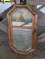 Full view of framed mirror showing painting above and mirror below