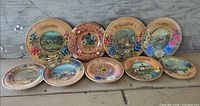 All nine wooden decorative plates front view