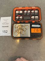 Ten yellow gold ring mounts on scale showing 21.61 g