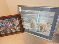 Both framed artworks leaning against wall for size comparison