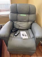Full view of gray Golden power lift recliner with accessories on seat