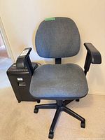 Gray fabric task chair in front of shredder