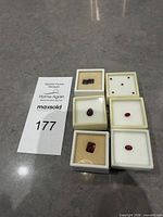 All six gem boxes showing assorted garnet and ruby stones