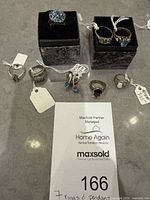 All items grouped with ID slip showing seven rings and pendant