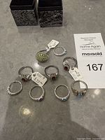 All nine rings laid out with two empty ring boxes