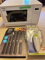 Panasonic microwave with boxed knife set and two sealed can openers