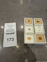 All seven citrine gemstones in individual display boxes