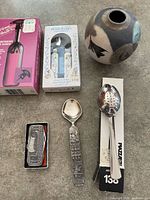 Utensils, wine opener box, vase, pocket knife tin