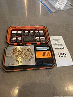 assorted gold findings on scale in case showing quantity
