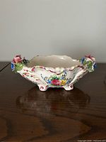 overall side view of ceramic bowl showing footed base and exterior decoration