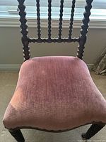 Front view showing full chair, spool legs, mauve seat