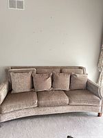 Front view of beige/taupe chenille 3-seat sofa with five back pillows and nailhead arms