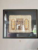 Framed papyrus artwork on wall showing full frame and mat