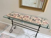 Full view of glass top console table against wall