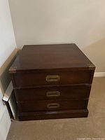 Front view closed drawers showing recessed brass pulls