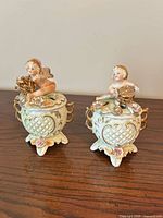 Pair of porcelain covered jars showing overall form and decoration
