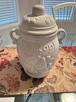 Front view of assembled Rumtopf with lid showing embossed decoration, handles, knobbed lid