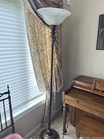 Full view of floor lamp beside window and desk