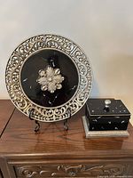 Charger plate on stand with trinket box on table