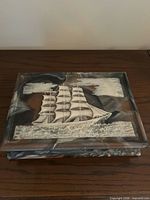 Closed jewelry box showing sailing ship relief lid