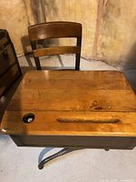 Top view showing wood desktop with inkwell hole, pencil groove and attached chair backrest