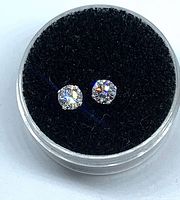 Pair of diamond stud earrings in display case