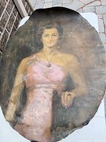 Full view of oval canvas showing portrait of woman in pink dress, visible wear and frayed edges